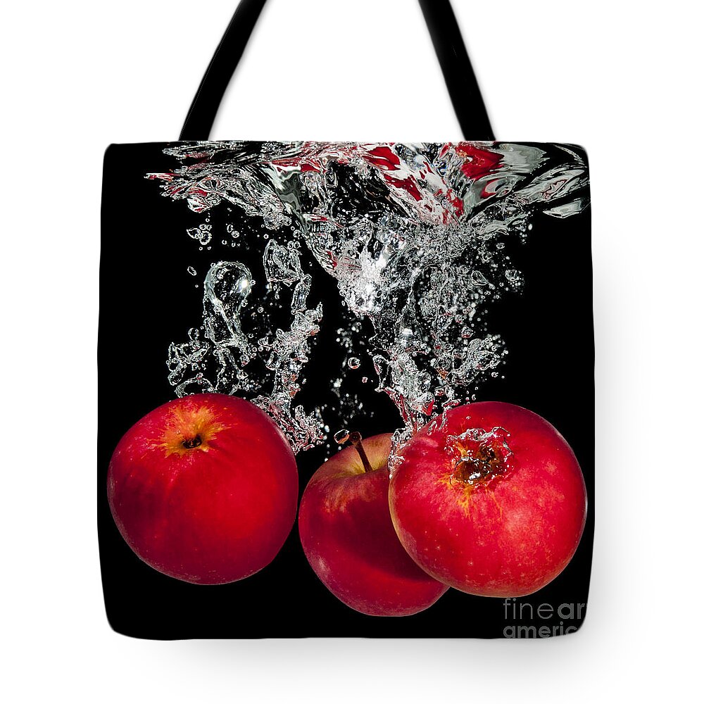 Apples Tote Bag featuring the photograph Splashing apples by Mike Santis