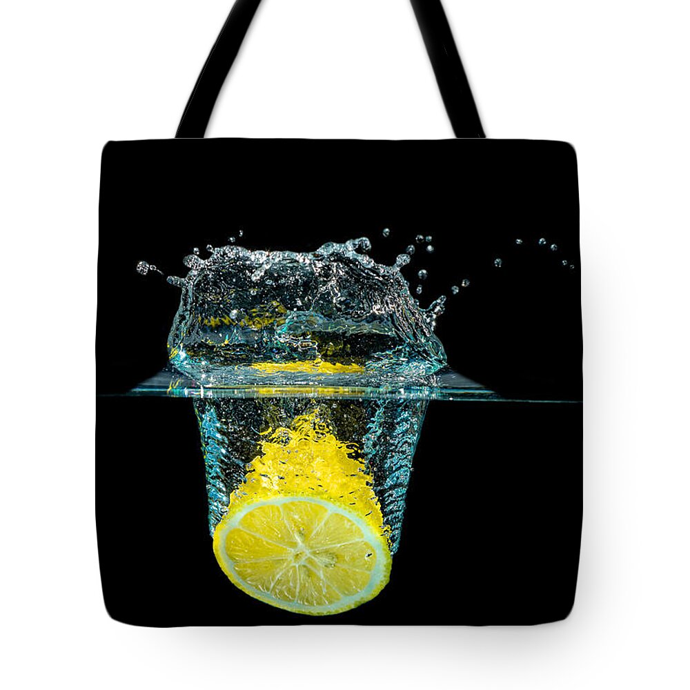 Beverage Tote Bag featuring the photograph Splashing Lemon by Peter Lakomy