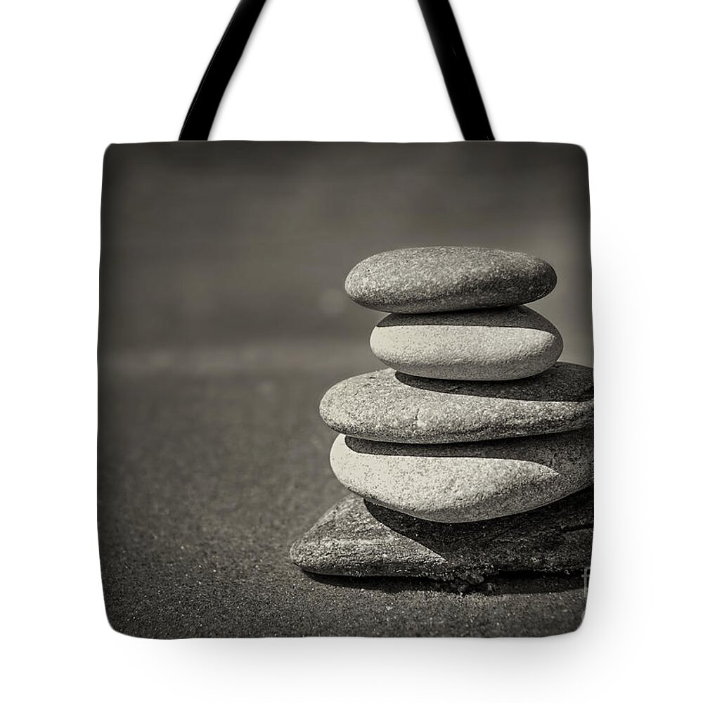 Rock Tote Bag featuring the photograph Stacked pebbles on beach by Elena Elisseeva