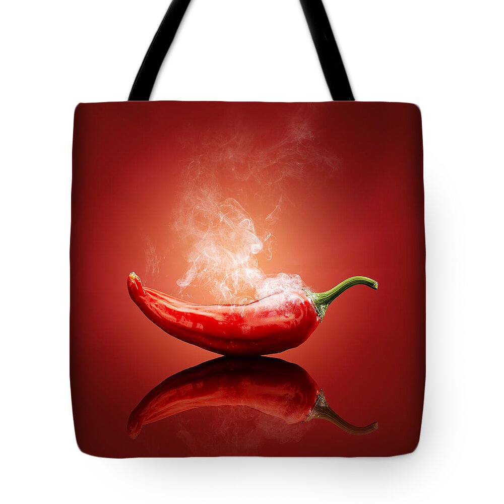Chillichiliredsmokesmokinghotburnburningsteamsteamingcapsicumcayennejalapenopaprikapeppergradientbackgroundreflectionreflectivetablestudioshotvegetablefreshconceptconceptualstilllifefoodripeimageonenobodyphotographindoors001019xs Tote Bag featuring the photograph Steaming hot Chilli by Johan Swanepoel