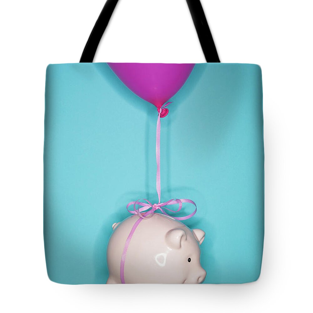 Working Tote Bag featuring the photograph Studio Shot Of Piggy Bank Lifted By by Tetra Images