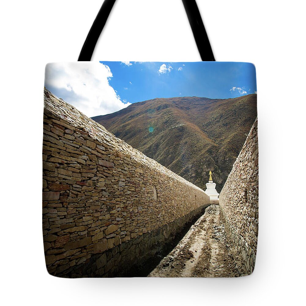 Tranquility Tote Bag featuring the photograph Stupa In A Mani Stone Wall by Yves Andre