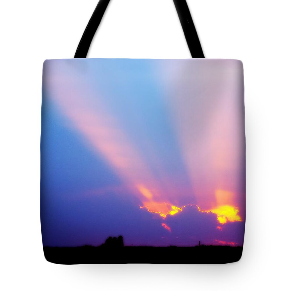 Sunset Tote Bag featuring the photograph Sun rays at Sunset by Eric Benjamin