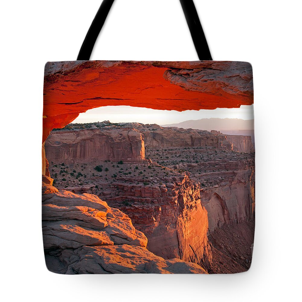 Canyonlands Np Tote Bag featuring the photograph Sunrise Mesa Arch Canyonlands National Park by Fred Stearns