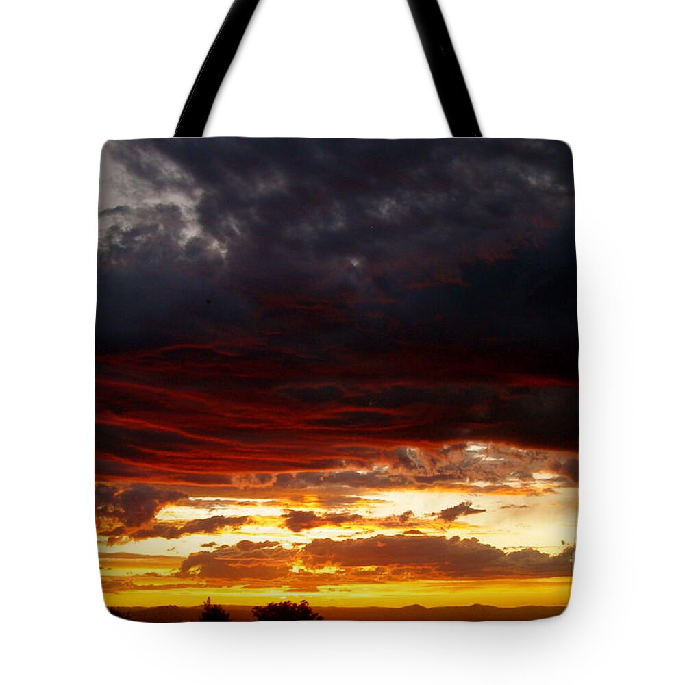 Sunset Tote Bag featuring the photograph Sunset in red by LeLa Becker