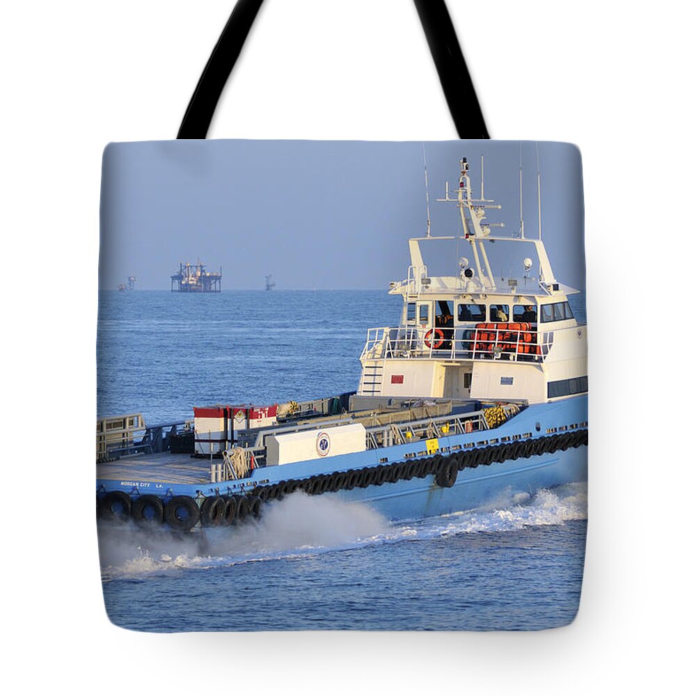 Supply Vessel Tote Bag featuring the photograph Supply Vessel heads to sea by Bradford Martin