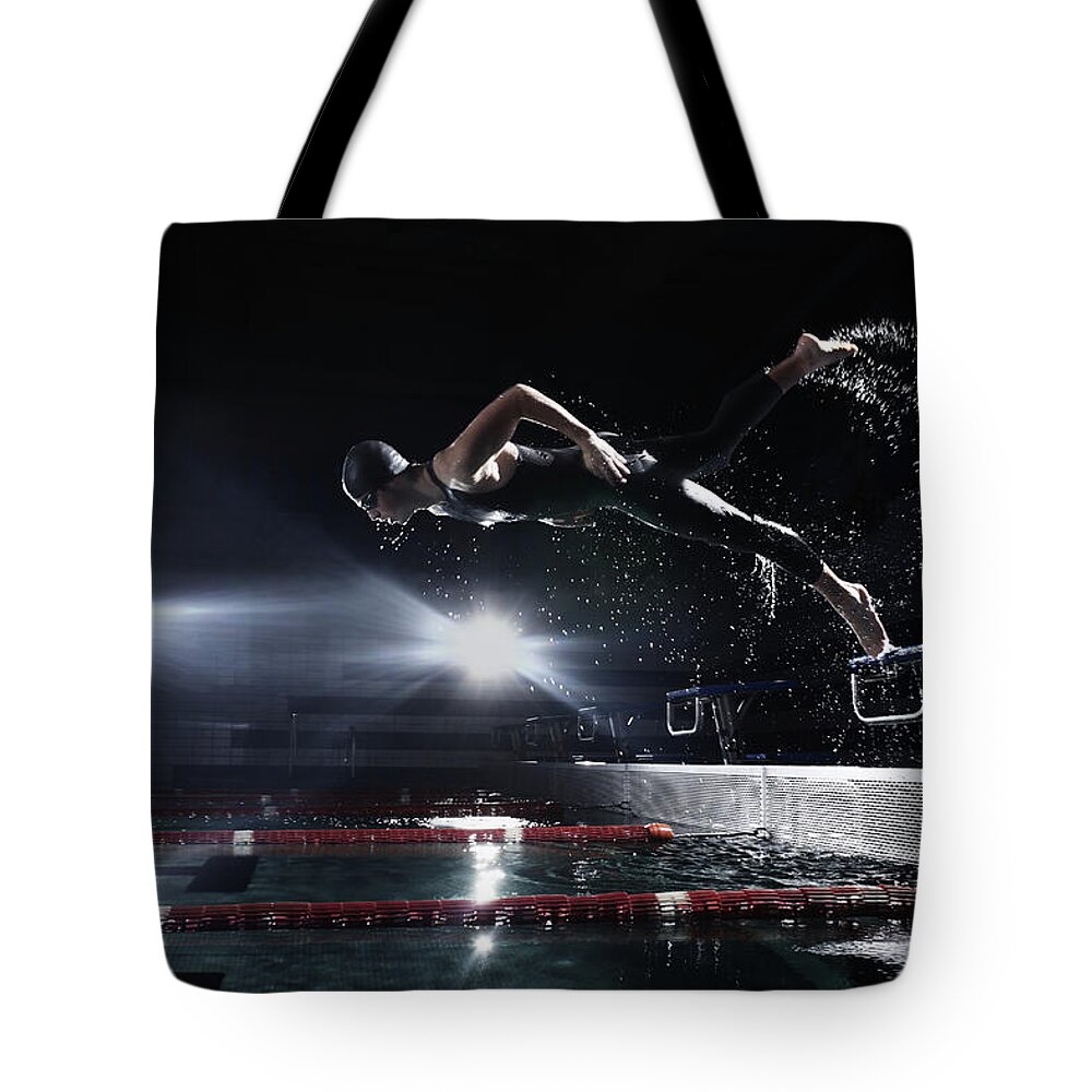 People Tote Bag featuring the photograph Swimmer Jumping From Starting Platform by Stanislaw Pytel