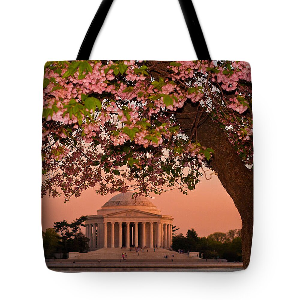 America Tote Bag featuring the photograph The Jefferson Memorial Framed by a Cherry Tree by Mitchell R Grosky