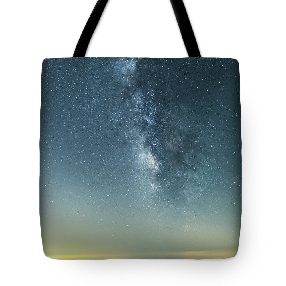 Scenics Tote Bag featuring the photograph The Milky Way Hovering Above A Town by Trevor Williams