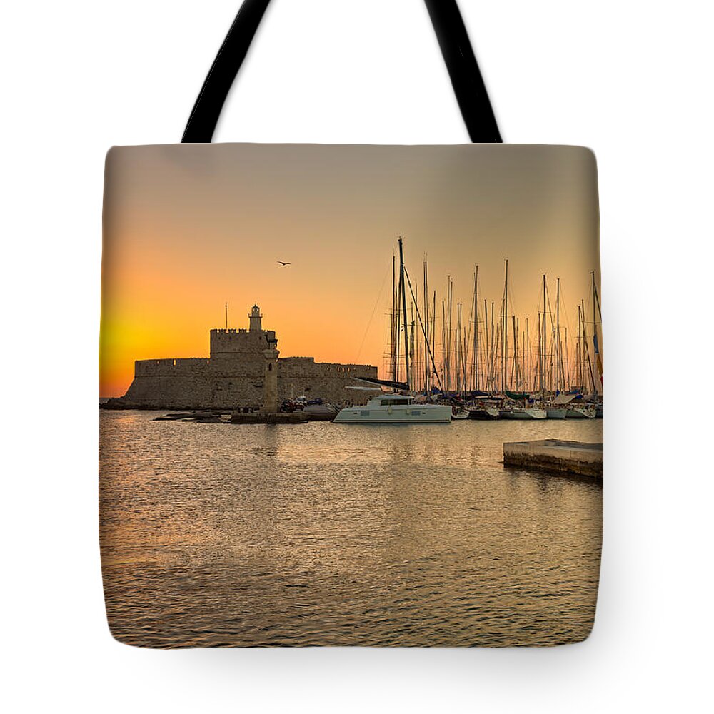 Aegean Tote Bag featuring the photograph The sunrise at the old port of Rhodes - Greece by Constantinos Iliopoulos