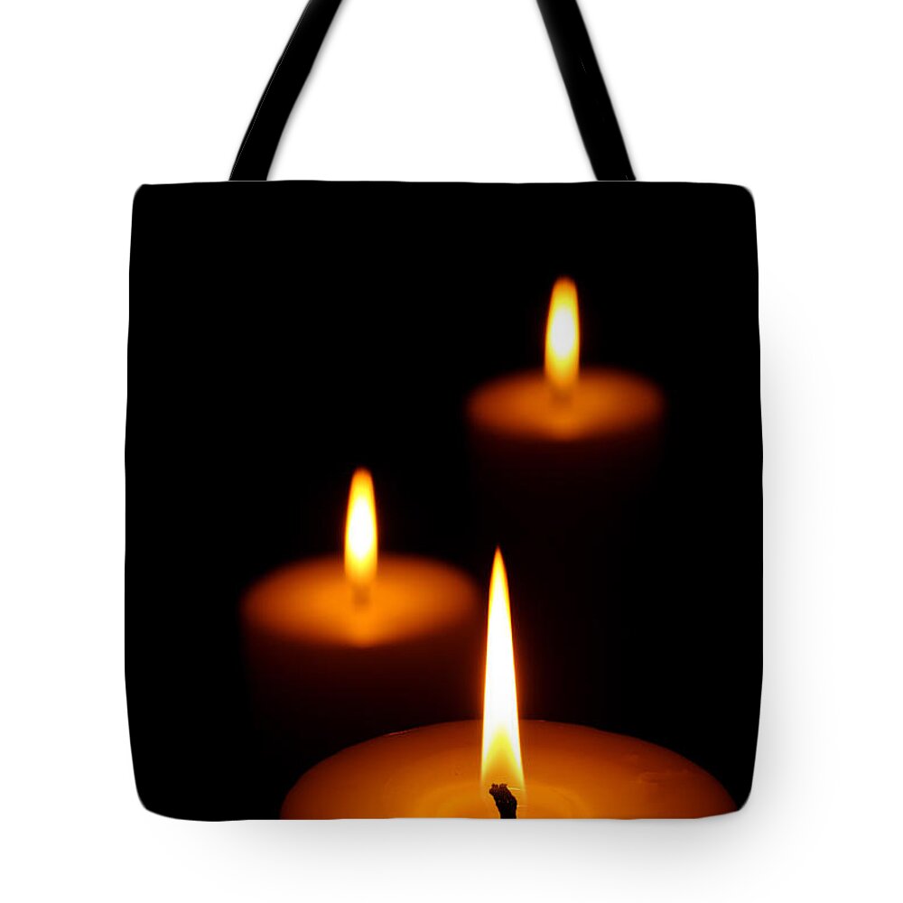Candle Tote Bag featuring the photograph Three Burning candles by Johan Swanepoel