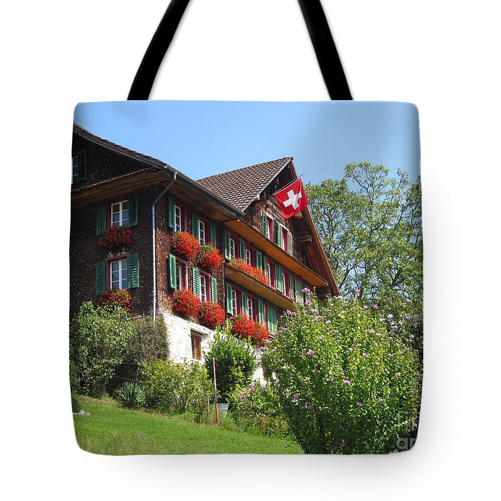Architecture Tote Bag featuring the photograph Traditional wooden Swiss House by Amanda Mohler