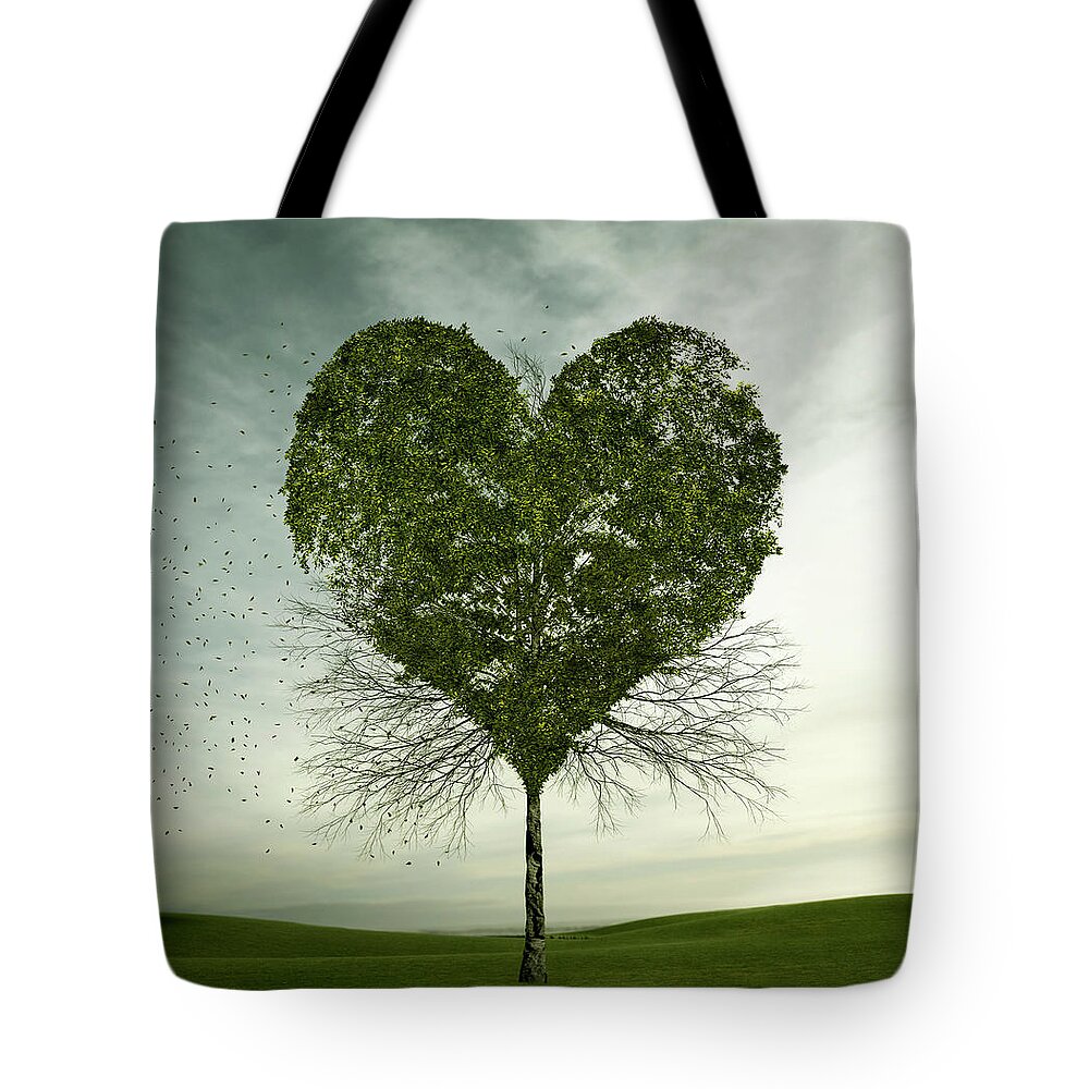 Environmental Conservation Tote Bag featuring the photograph Tree Growing In Heart-shape by Colin Anderson Productions Pty Ltd