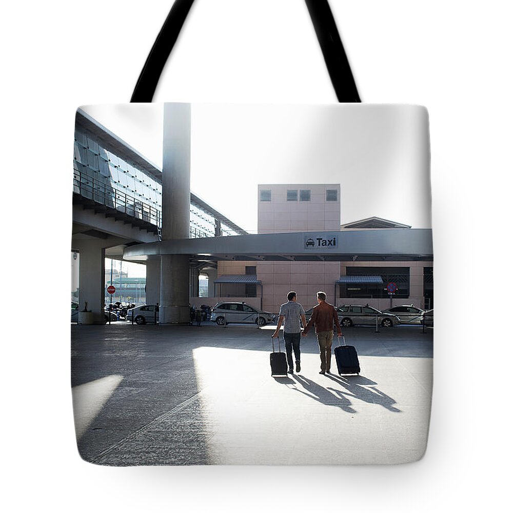 Mature Adult Tote Bag featuring the photograph Two Gay Men Walking To Taxi Rank by Gary John Norman
