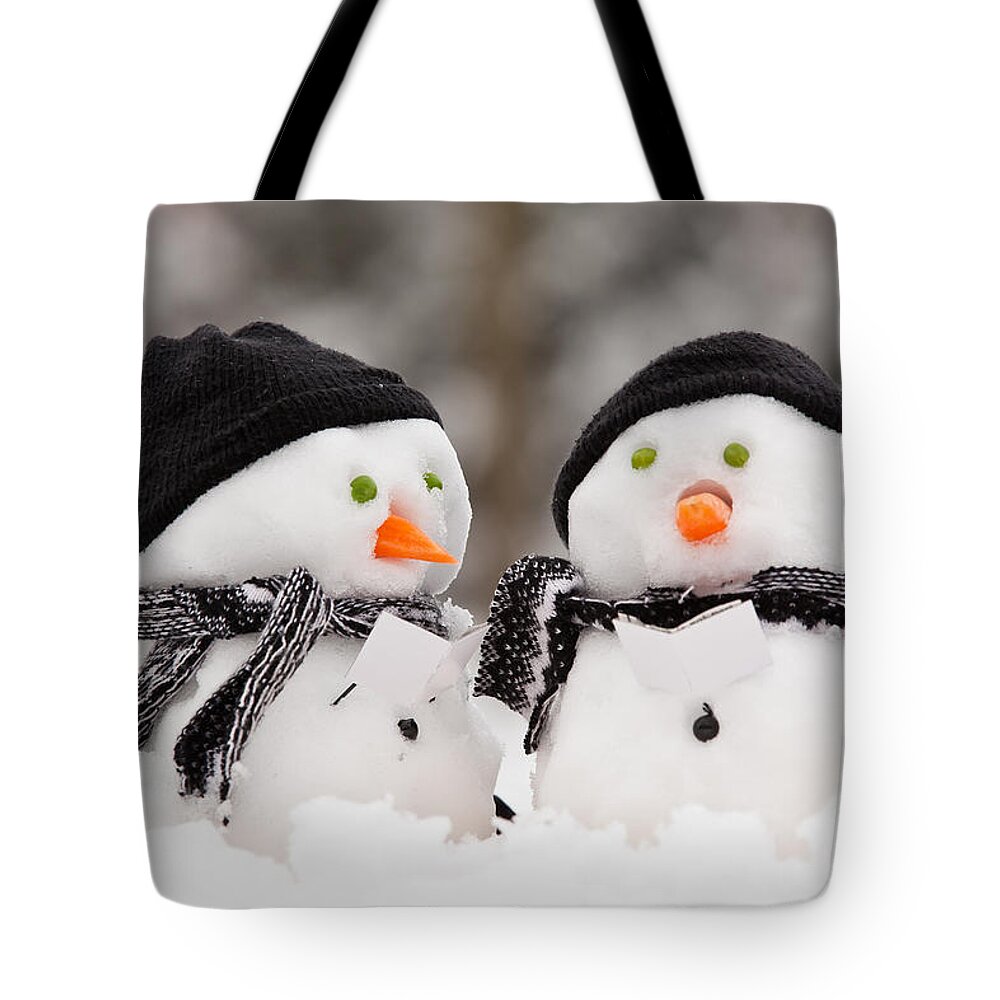 Snowmen Tote Bag featuring the photograph Two little snowmen by Simon Bratt