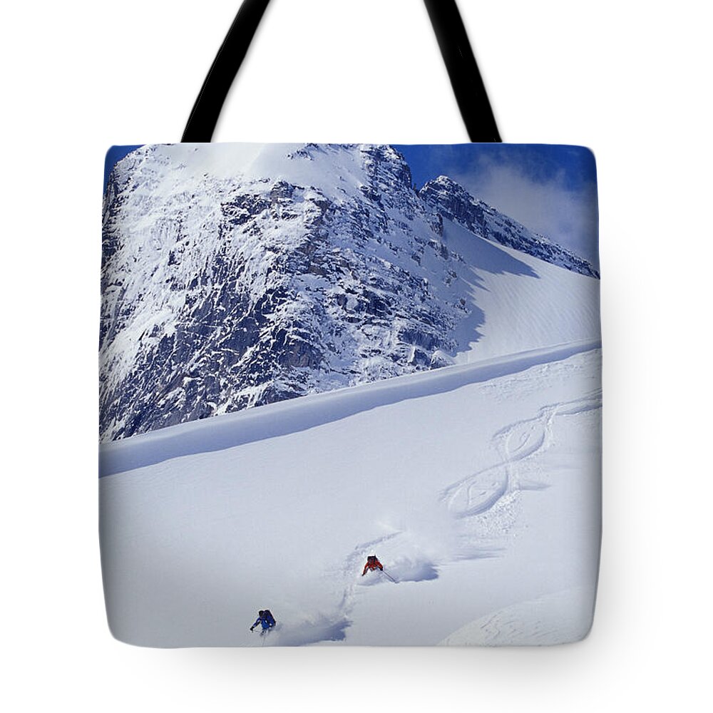 Action Tote Bag featuring the photograph Two Young Men Skiing Untracked Powder by Henry Georgi Photography Inc