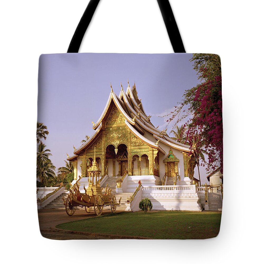 Luang Prabang Tote Bag featuring the photograph Wat Mai At Dusk by Shaun Higson