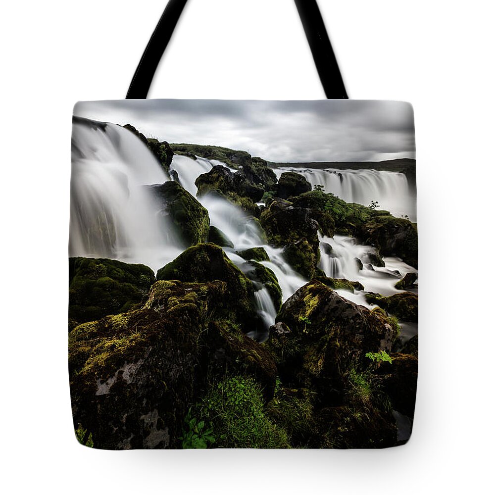 Toughness Tote Bag featuring the photograph Waterfall Pouring Over Rock Formations by Pixelchrome Inc