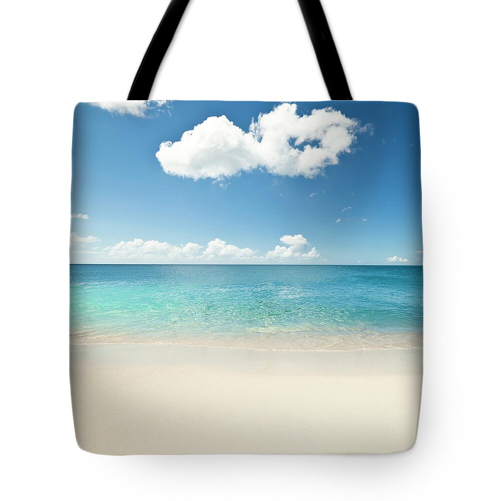 Water's Edge Tote Bag featuring the photograph White Sandy Caribbean Beach by Guvendemir