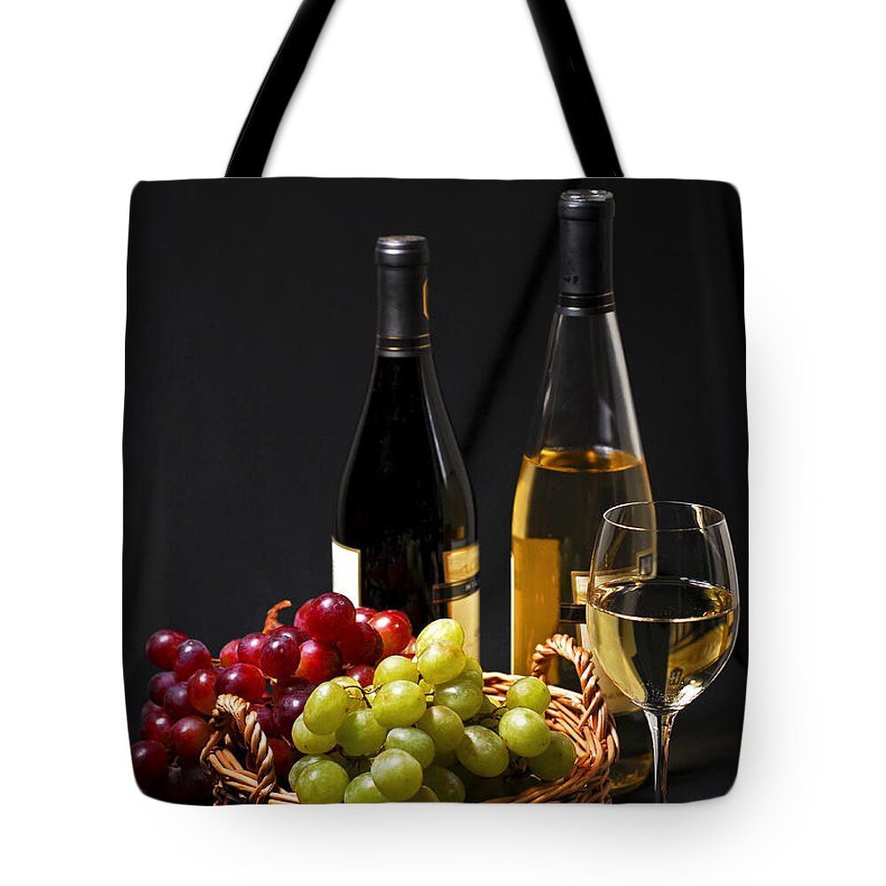 Wine Tote Bag featuring the photograph Wine and grapes by Elena Elisseeva
