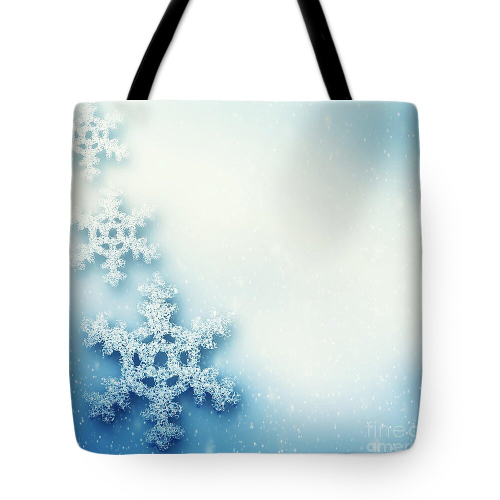 Snowflake Tote Bag featuring the photograph Winter Christmas background with big snowflakes by Michal Bednarek