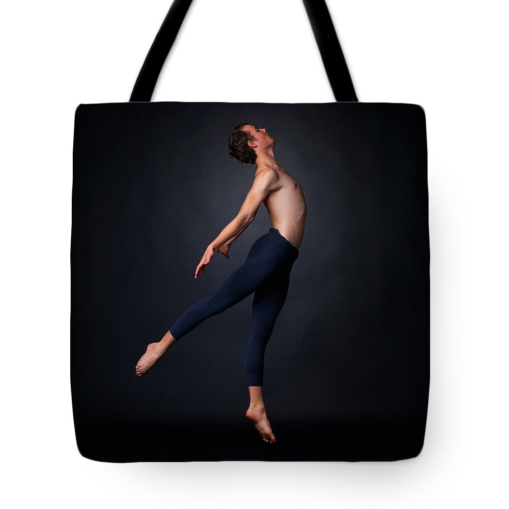 Ballet Dancer Tote Bag featuring the photograph Young Ballet Dancer Performing Against by Yuri
