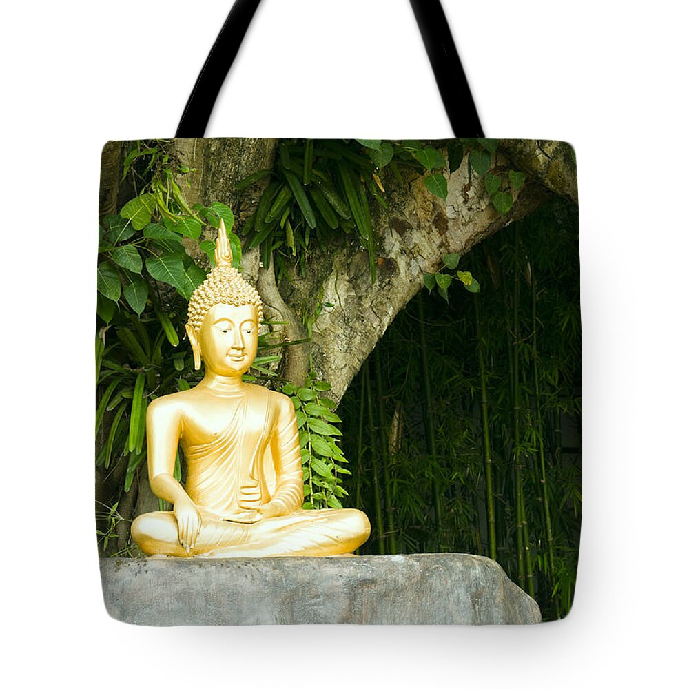 Beautiful Tote Bag featuring the photograph Buddha statue under green tree in meditative posture #1 by U Schade