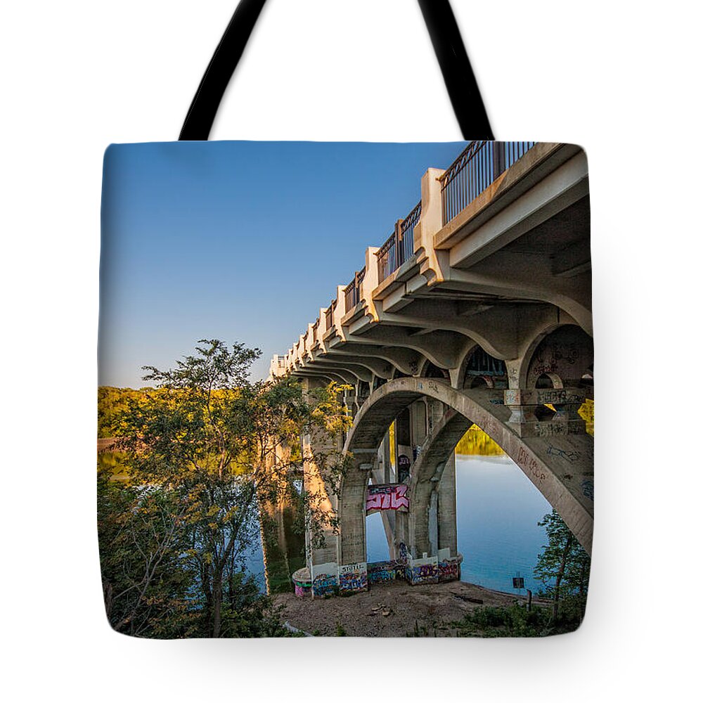 Bridge River Minnesota Sky Water Trees Graffiti Saint Paul Tote Bag featuring the photograph Ford Parkway Bridge #1 by Tom Gort