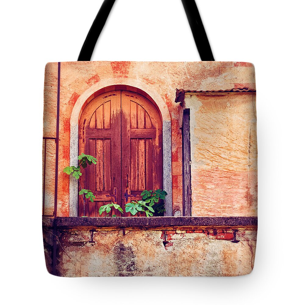Door Tote Bag featuring the photograph Abandoned building door with leaves by Silvia Ganora