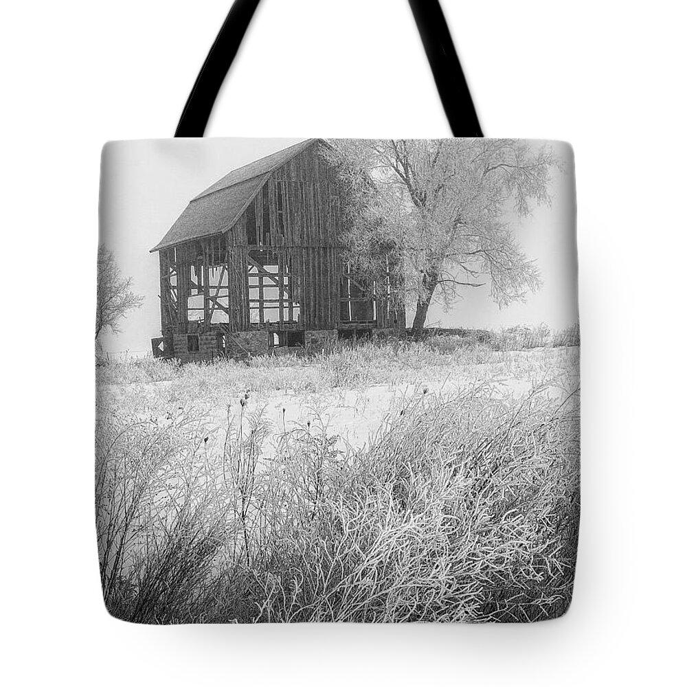 Barn Tote Bag featuring the photograph Black and white photo of an old dilapitated barn in an early morning hoar frost by Randall Nyhof