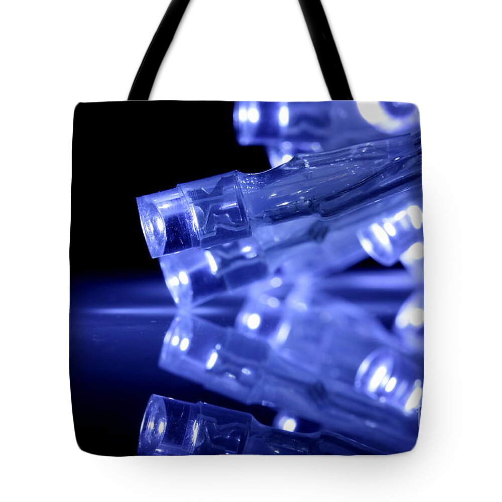Abstract Tote Bag featuring the photograph Blue LED lights closeup with reflection by Simon Bratt