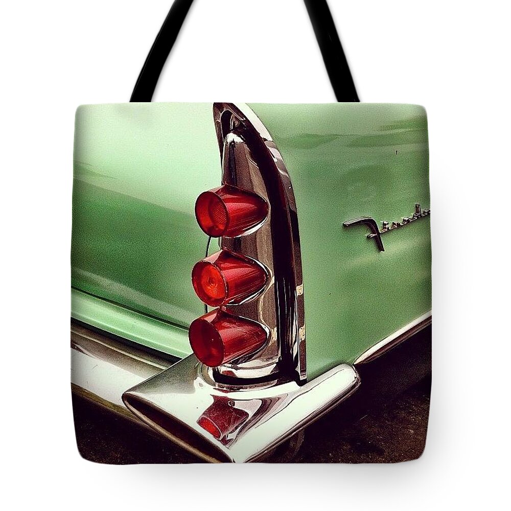 Classiccar Tote Bag featuring the photograph Classic car tail lamp by Julie Gebhardt
