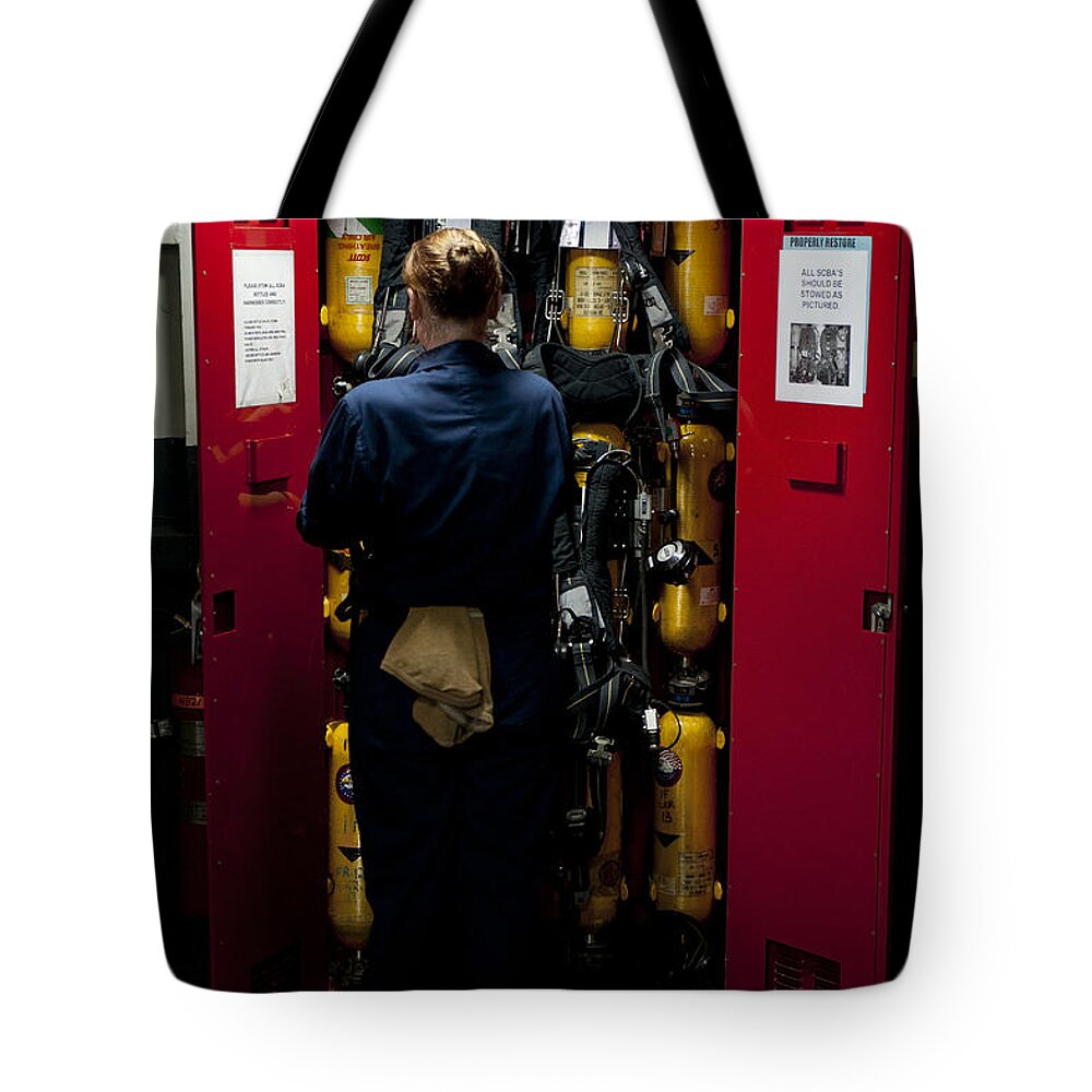 Breathing Apparatus Tote Bag featuring the photograph Fireman Stows A Self-contained by Stocktrek Images