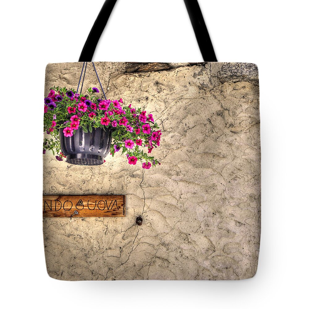 Flowers Tote Bag featuring the photograph Flowers and a signboard by Mats Silvan