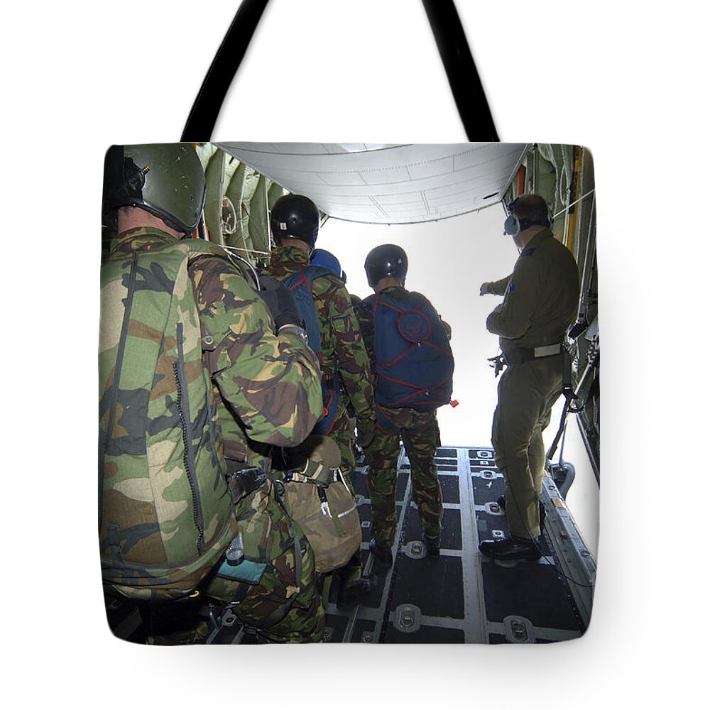 British Army Tote Bag featuring the photograph Members Of The Pathfinder Platoon Wait by Andrew Chittock