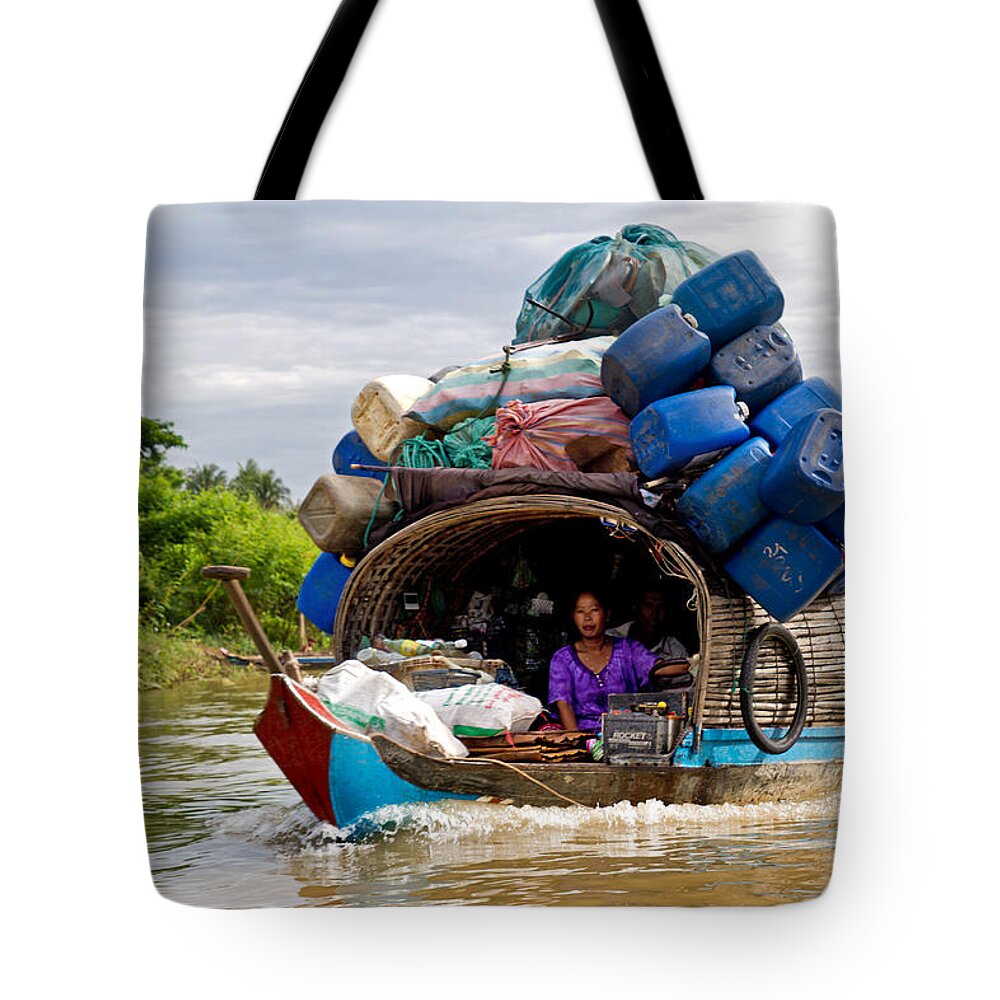 Cambodia Tote Bag featuring the photograph Sampan on the river. by David Freuthal