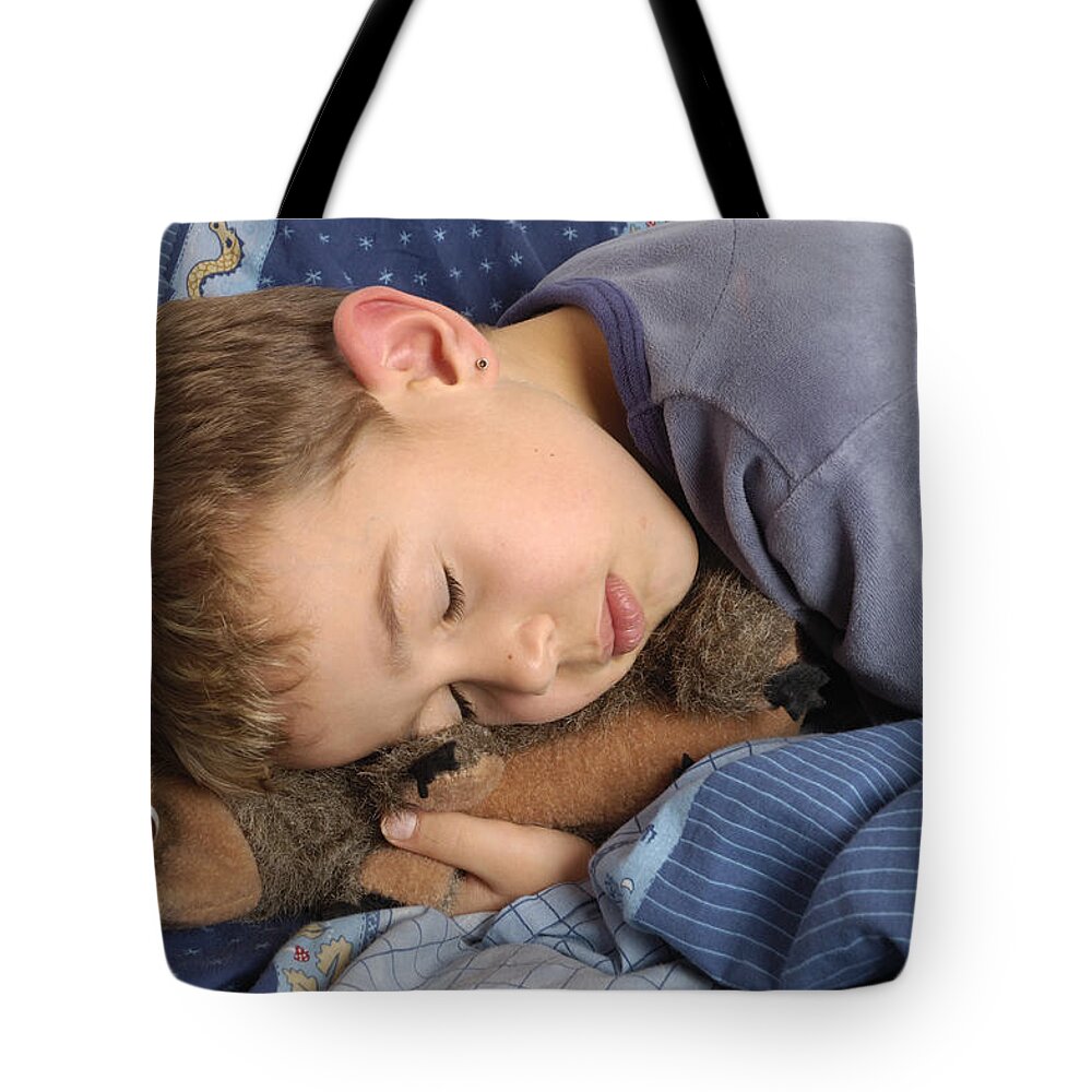 Sleeping Tote Bag featuring the photograph Sleeping child by Matthias Hauser
