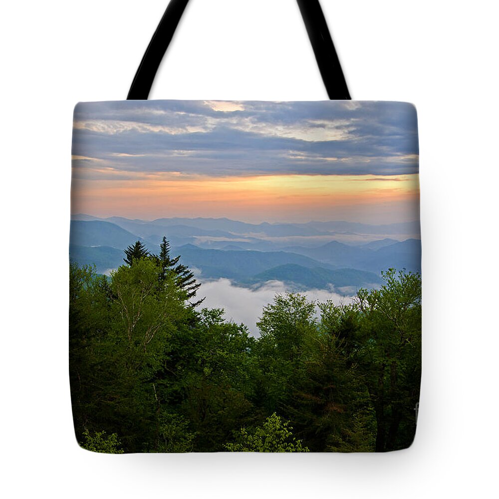 Sunset Tote Bag featuring the photograph Stormy Sunset by Bob and Nancy Kendrick