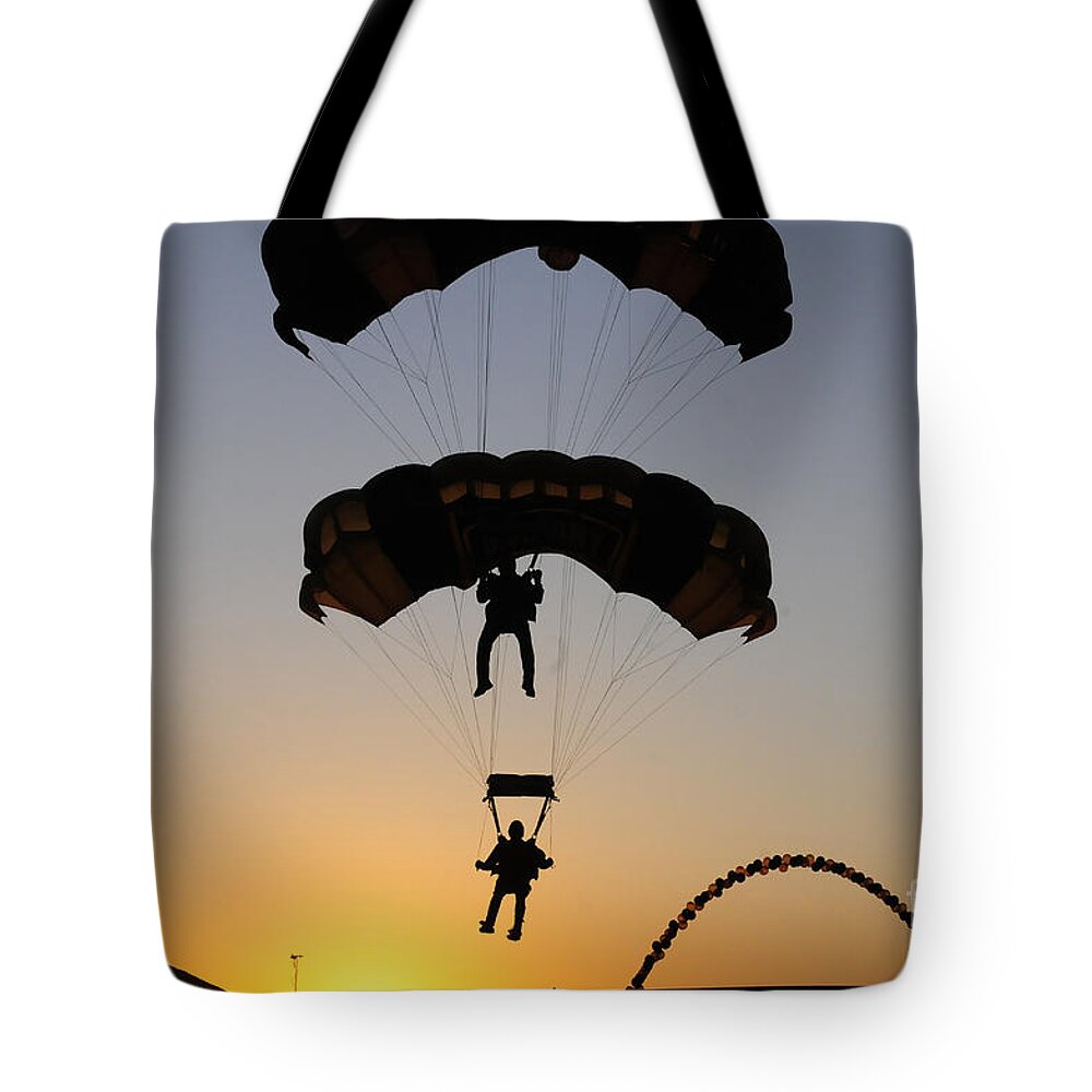 U.s. Army Golden Knights Tote Bag featuring the photograph The U.s. Army Golden Knights Perform An by Stocktrek Images