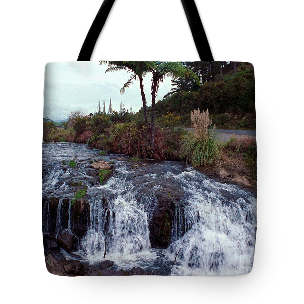 Waterfall Tote Bag featuring the photograph The waterfall in the stream by Mark Dodd