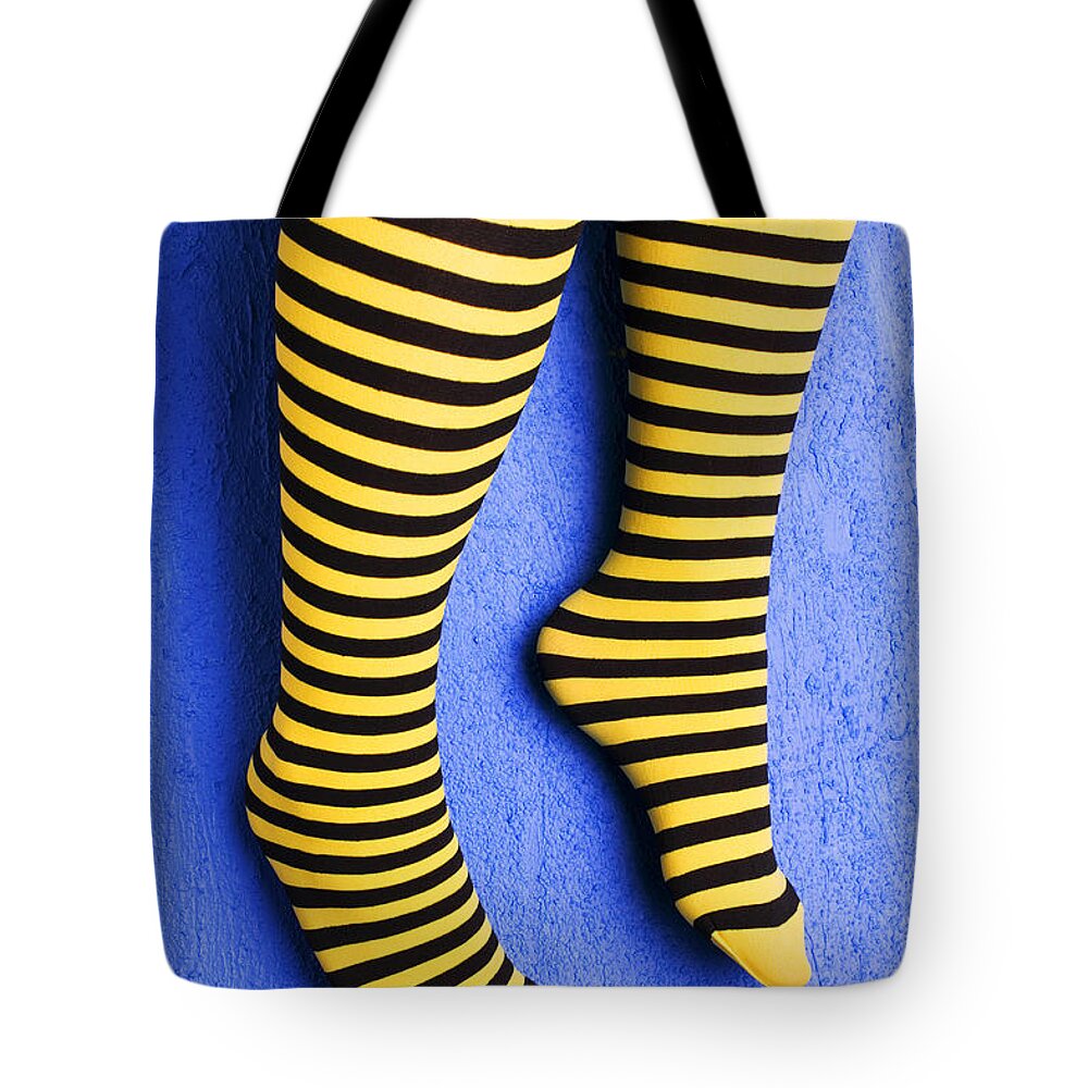 Leg Tote Bag featuring the photograph Two legs against blue wall by Garry Gay