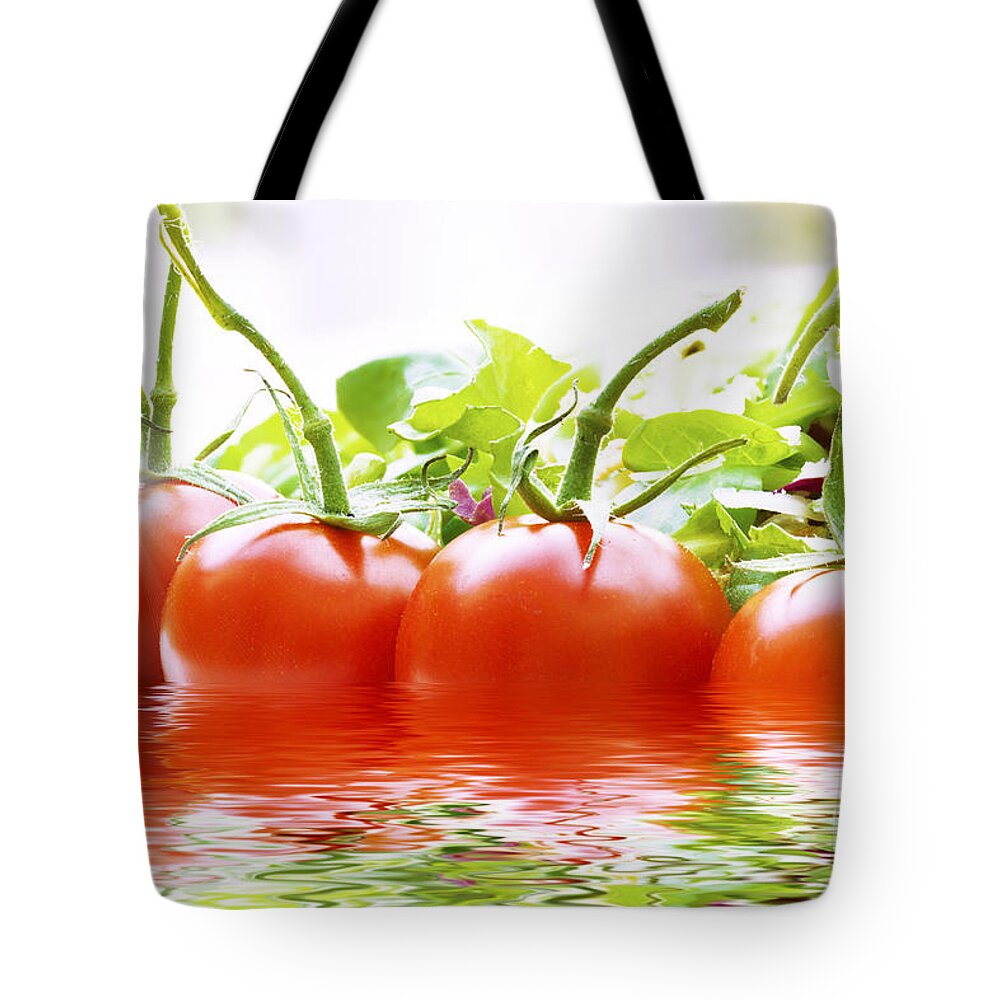 Food Tote Bag featuring the photograph Vine tomatoes and salad with water by Simon Bratt