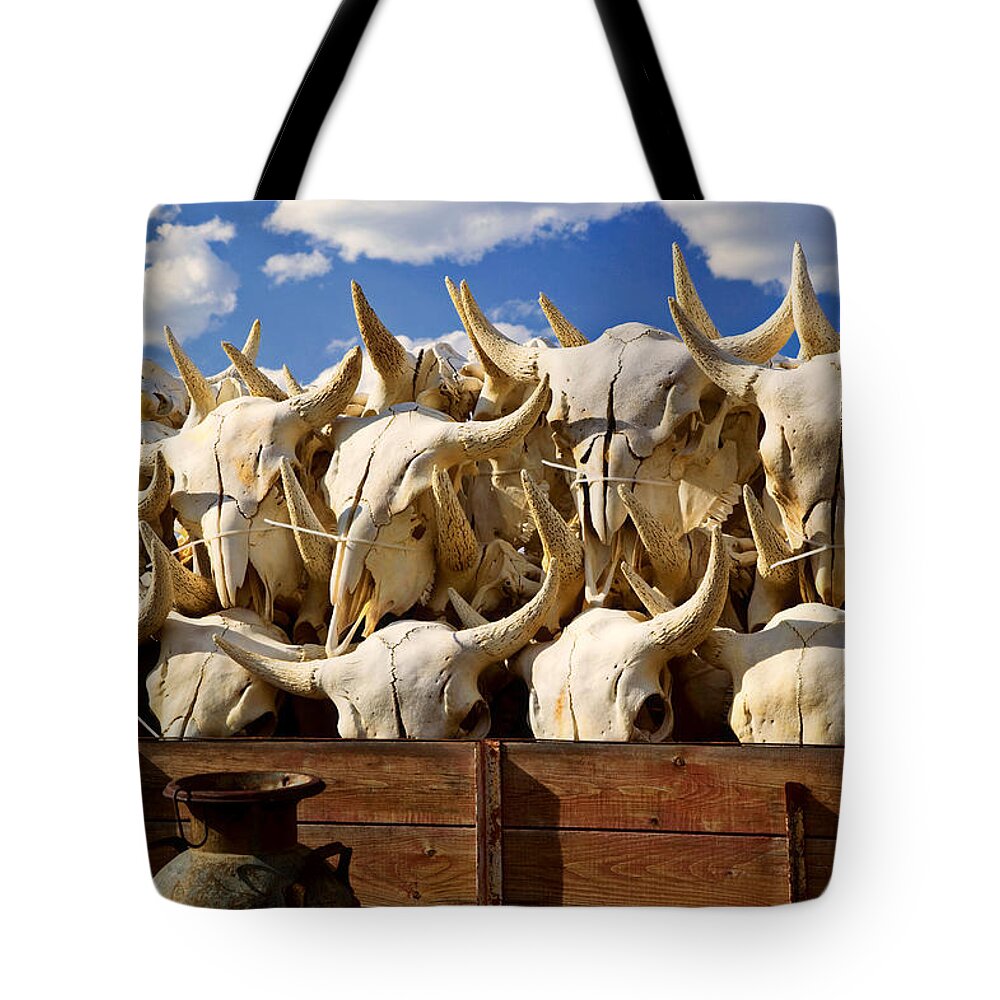 Bison Skulls Tote Bag featuring the photograph Wagon full of animal skulls by Garry Gay