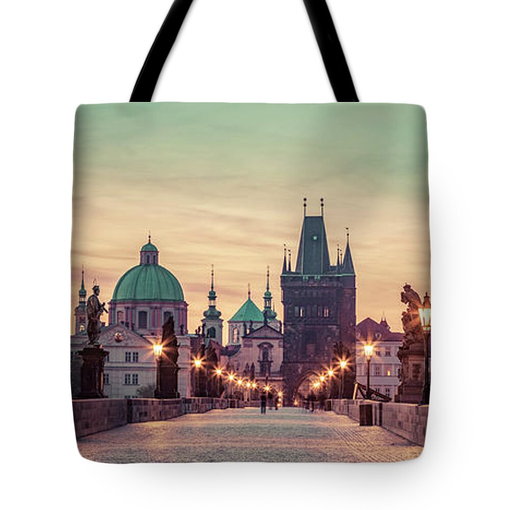 Prague Tote Bag featuring the photograph Charles Bridge at sunrise, Prague, Czech Republic. Dramatic statues and medieval towers. #1 by Michal Bednarek