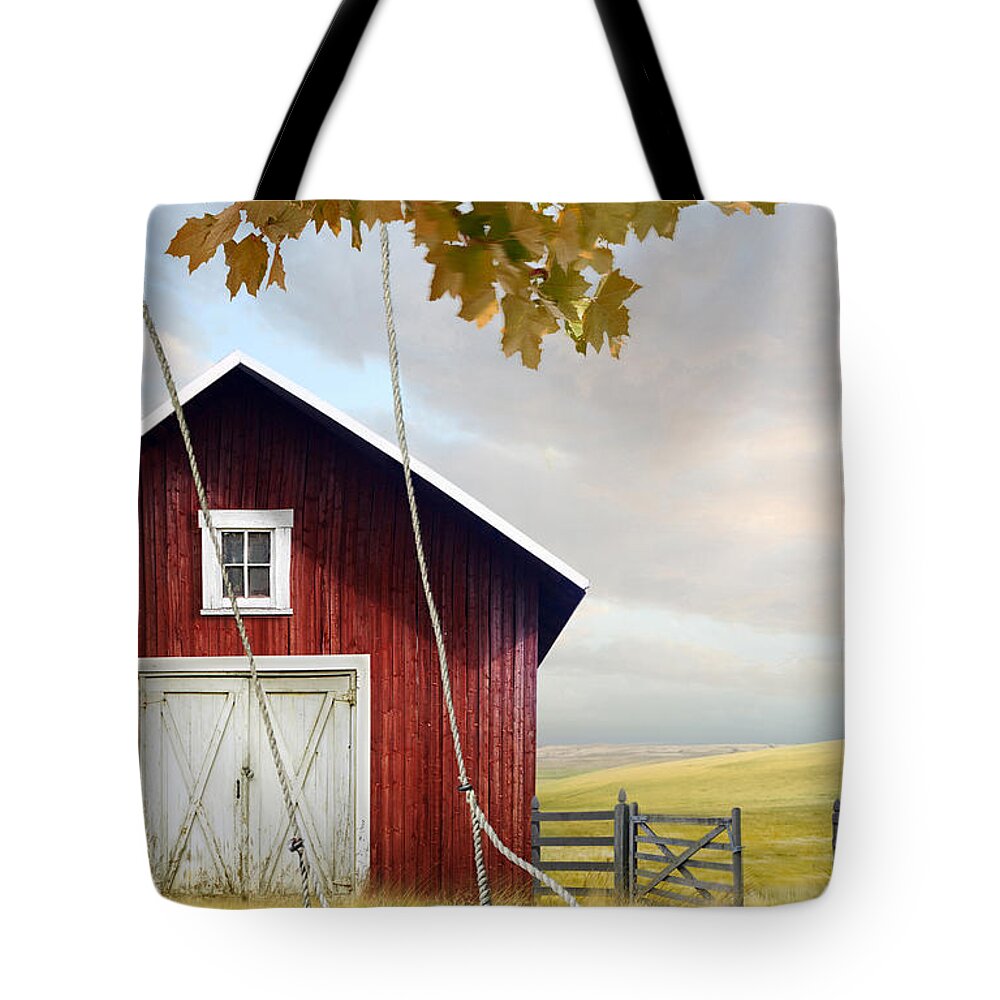 Atmosphere Tote Bag featuring the photograph Large red barn with bicycle in field of wheat #1 by Sandra Cunningham