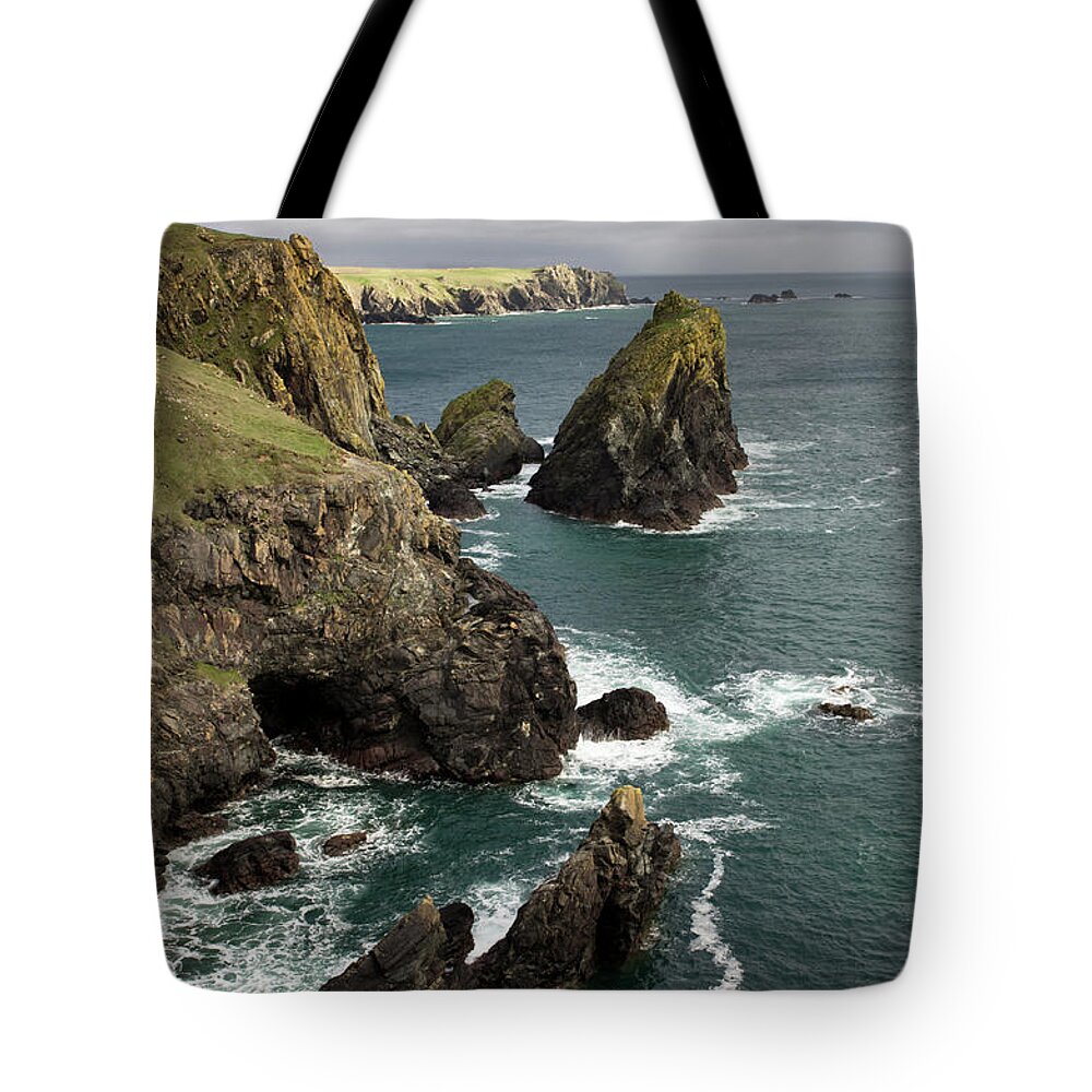 Kynance Cove Cornwall Tote Bag featuring the photograph Lions Rock near Kynance #1 by Pete Hemington