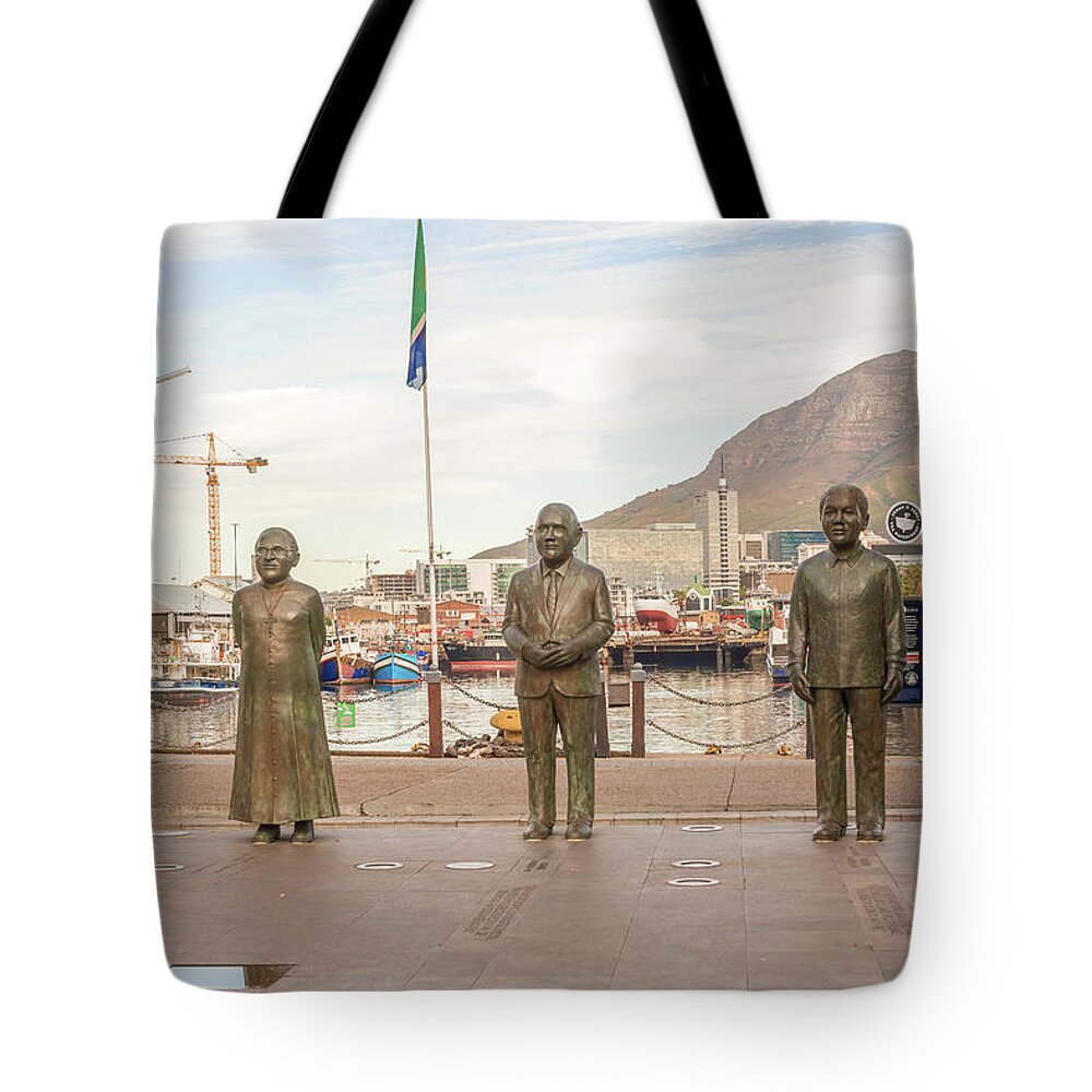 Bronze Tote Bag featuring the photograph Nobel Square at waterfront in Cape Town with the four statues of #1 by Marek Poplawski