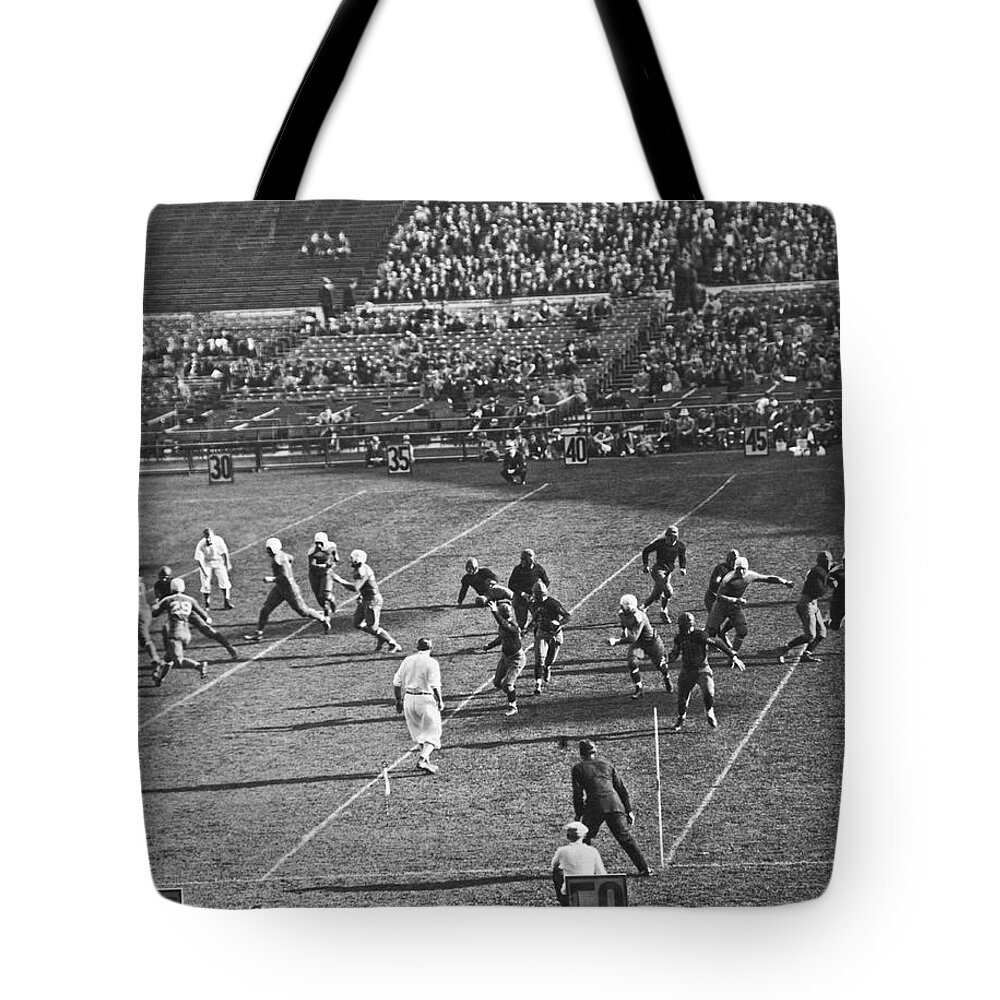 1910s Tote Bag featuring the photograph Quarterback Throwing Football #1 by Underwood Archives