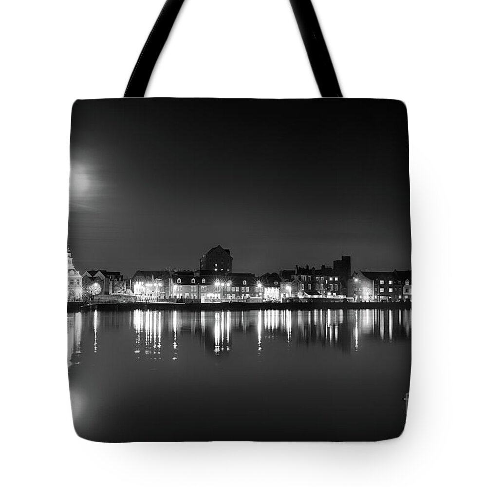 Kings Lynn Tote Bag featuring the photograph Super moon rising over Norfolk town UK by Simon Bratt
