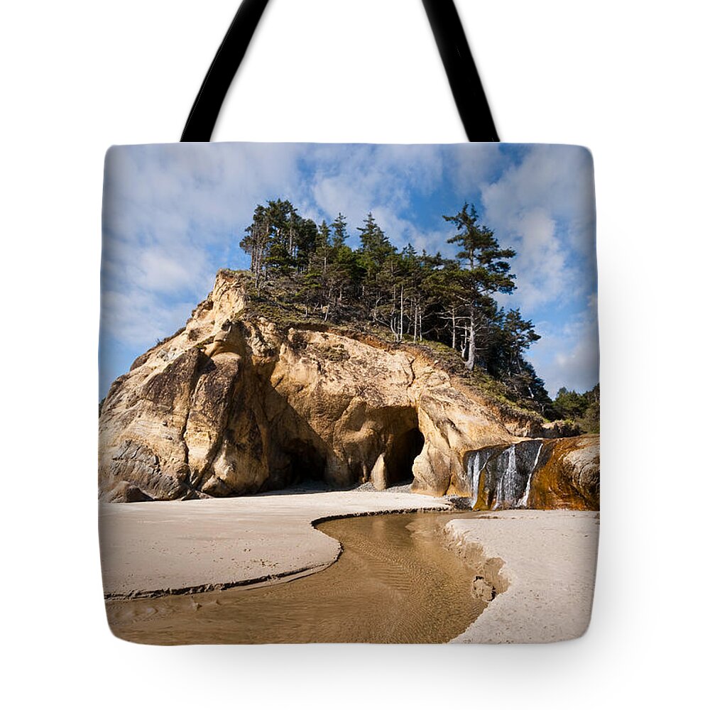Beach Tote Bag featuring the photograph Waterfall Flowing into the Pacific Ocean by Jeff Goulden